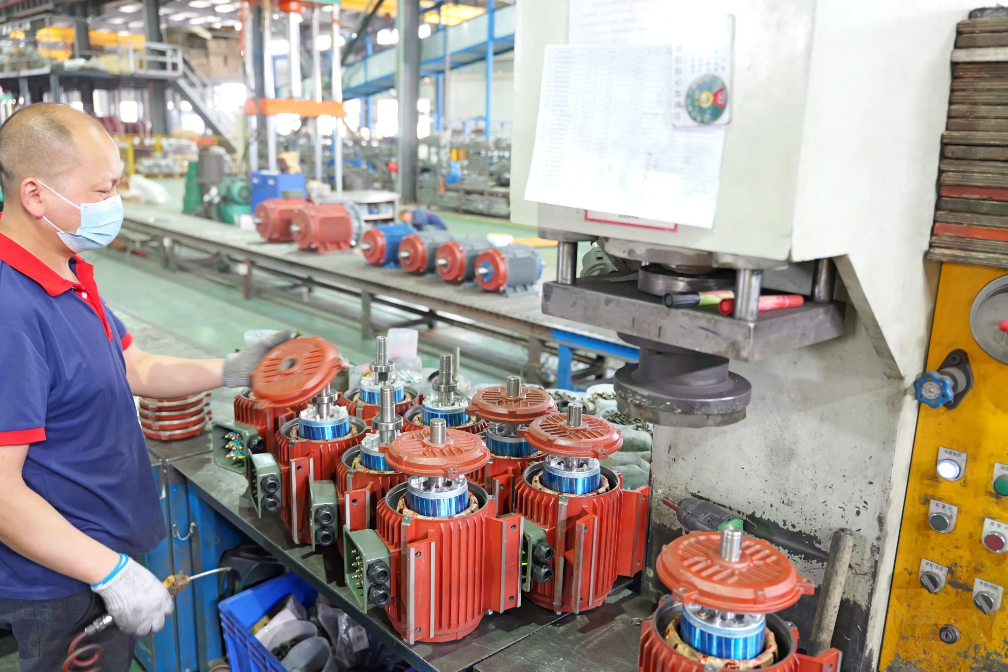 Industrial motor assembly workshop with rotor and casing fitting